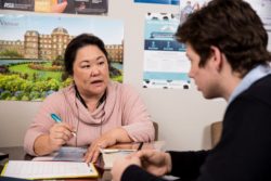 A student discusses matters with a staff member