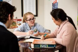 Students meet to learn for the SAT at a table in a learning environment