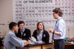 A chemistry teacher points to important facts