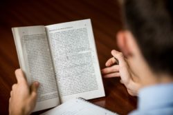 A student goes through the words in a text, emphasizing important passages