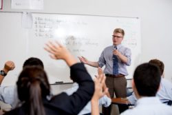 An instructor calls on a student with a raised hand